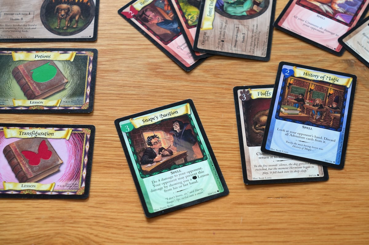Assorted collectible trading cards spread out after being sorted from a collection